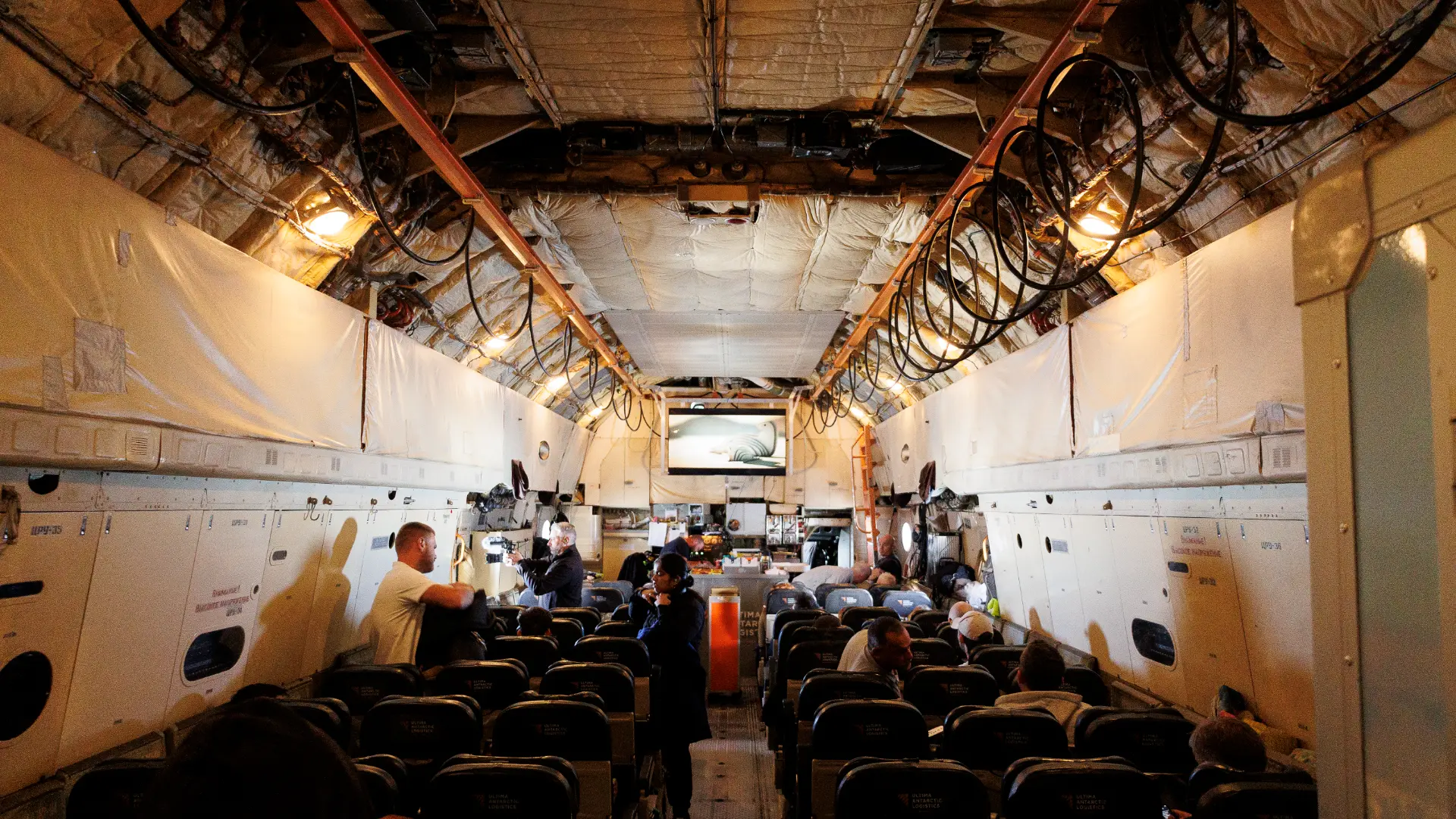 Inside the cargo cabin of the Ilyushin aircraft with the team seated for the flight to Antarctica